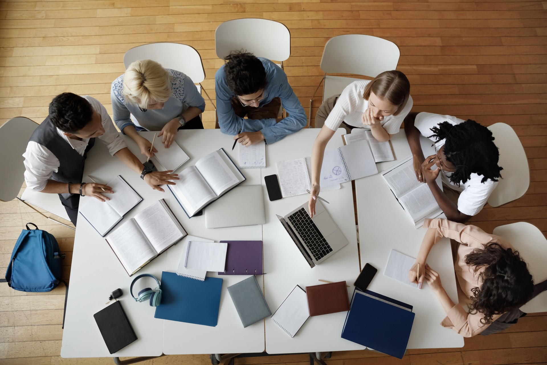 Team of young college students working on study project